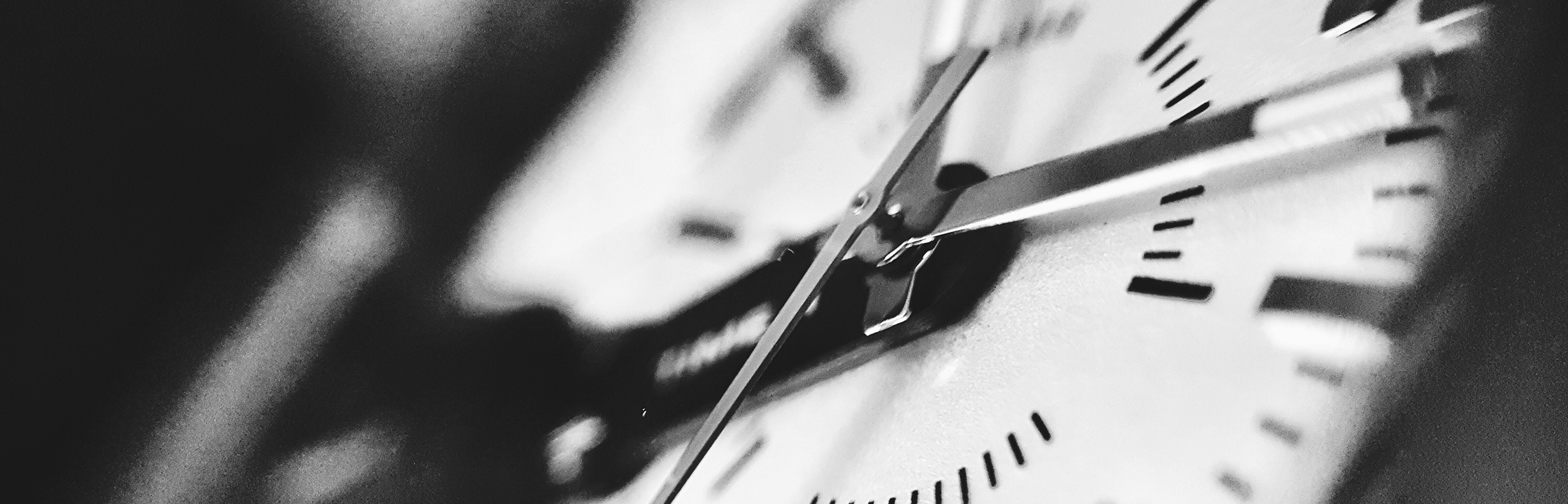 Black and white closeup of an analog clock